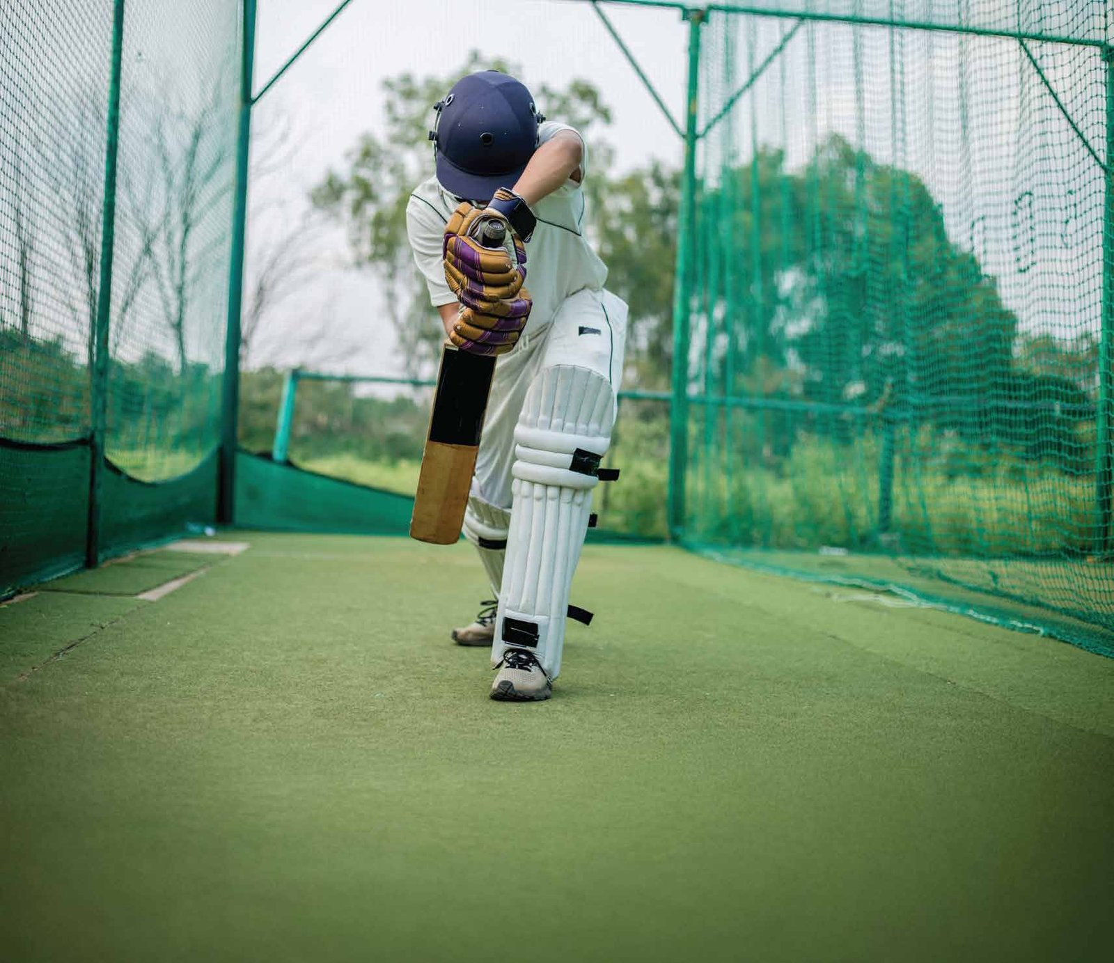 A young batter at the cricket pitch